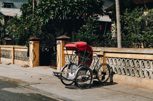 a bicycle parked on the side of a road next to a fence