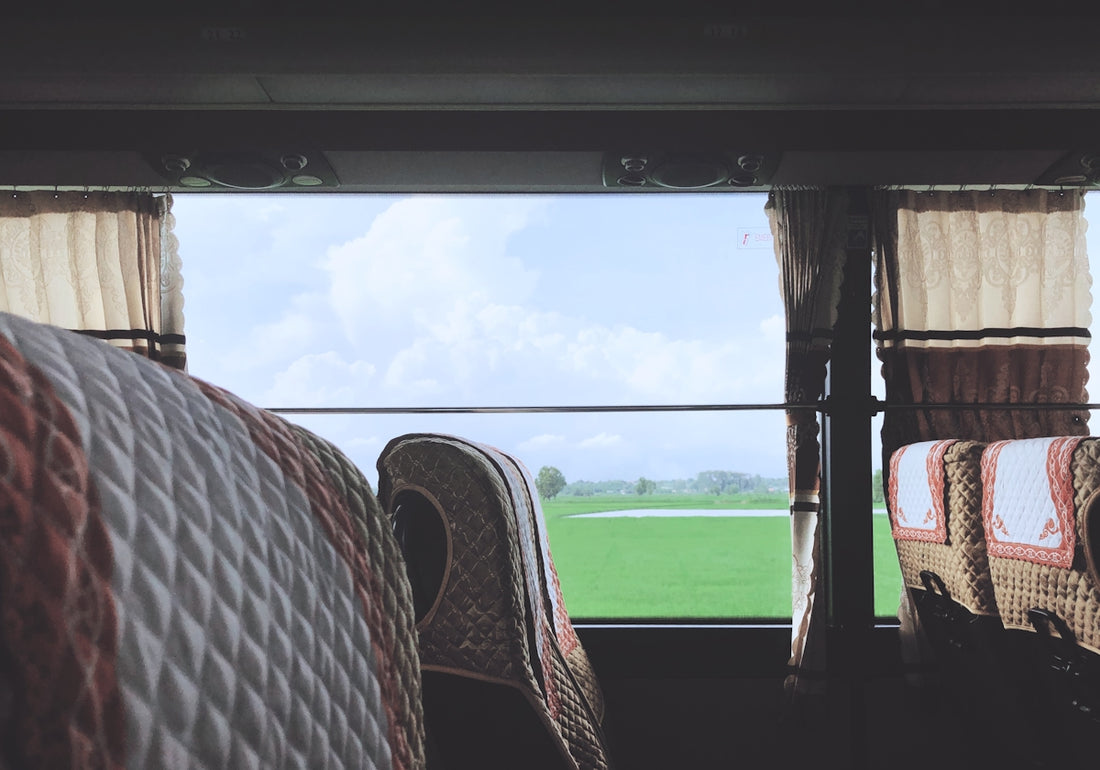 person in white and black stripe shirt sitting on brown wooden chair