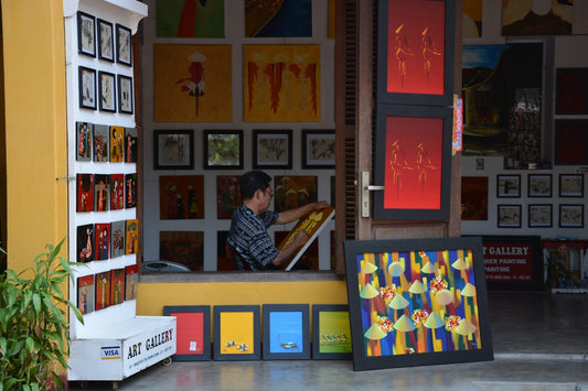 man in black and white striped shirt sitting beside woman in black and white stripe shirt