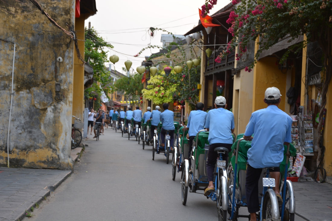people in green shirts riding bicycle on street during daytime