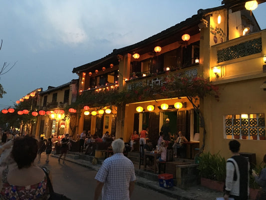 people sitting on bench near building during night time
