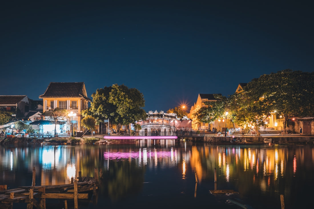brown and white house near body of water during night time