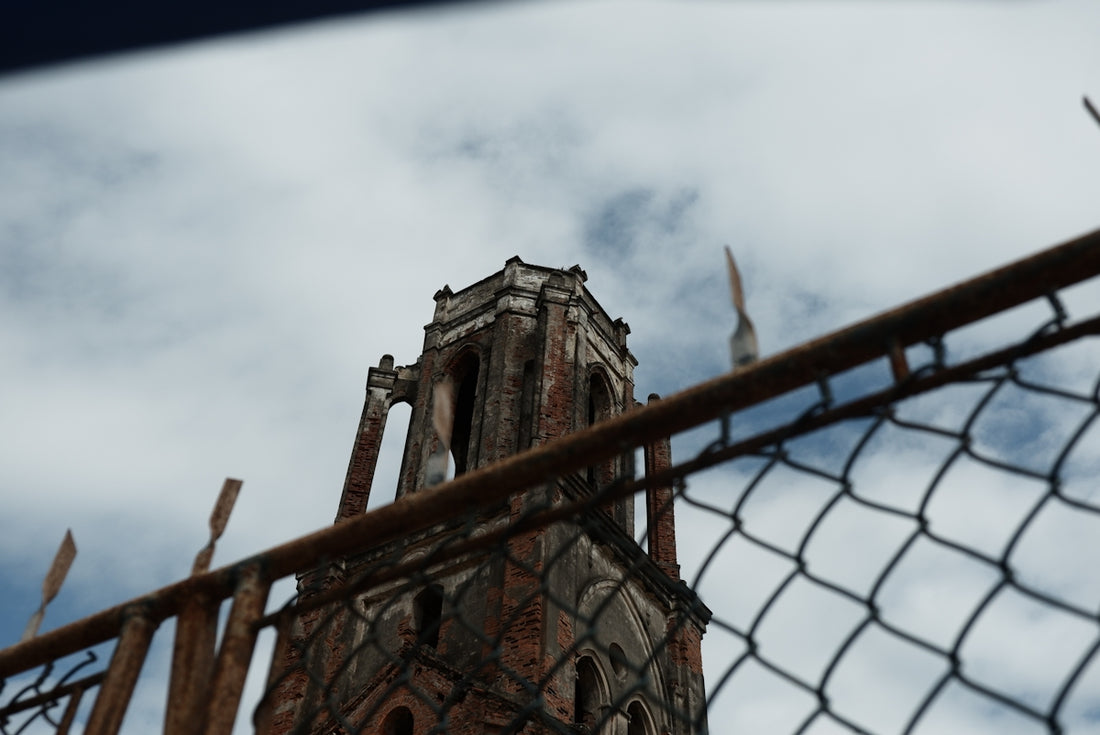 brown concrete building under white clouds during daytime