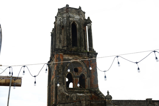 a very tall tower with a clock on it's side