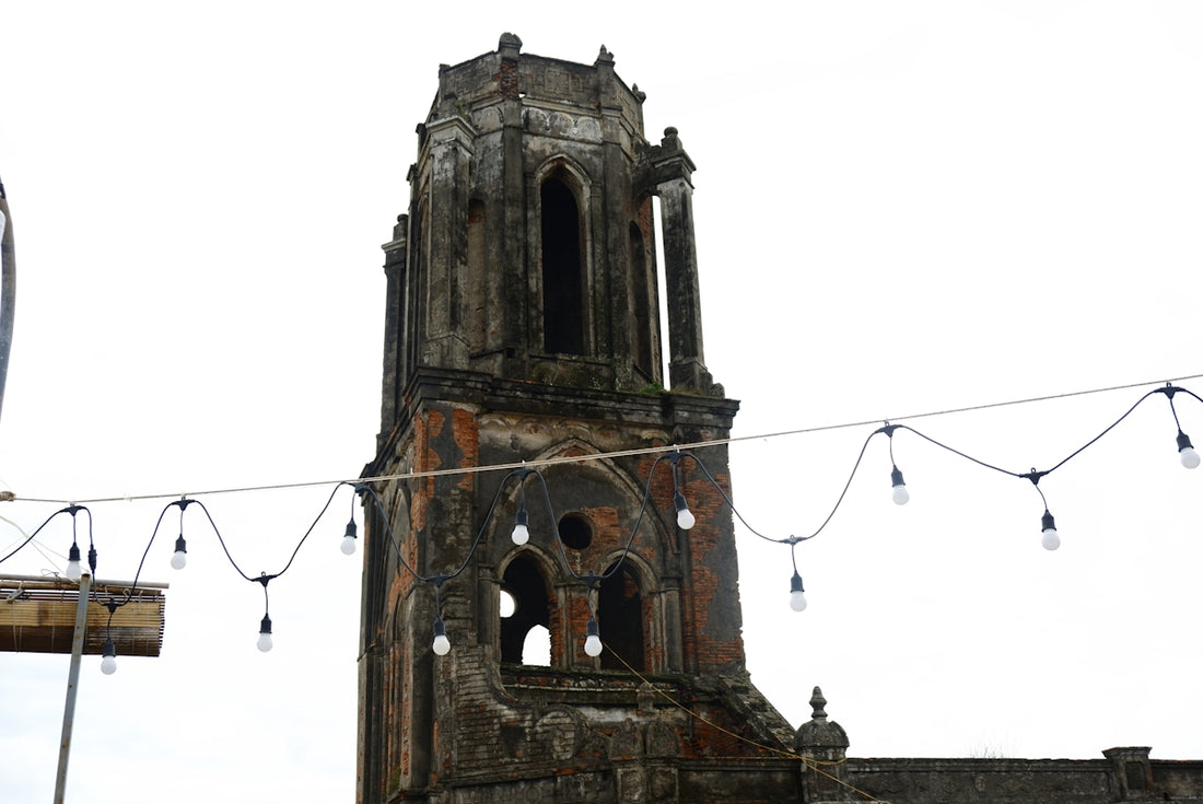 a very tall tower with a clock on it's side