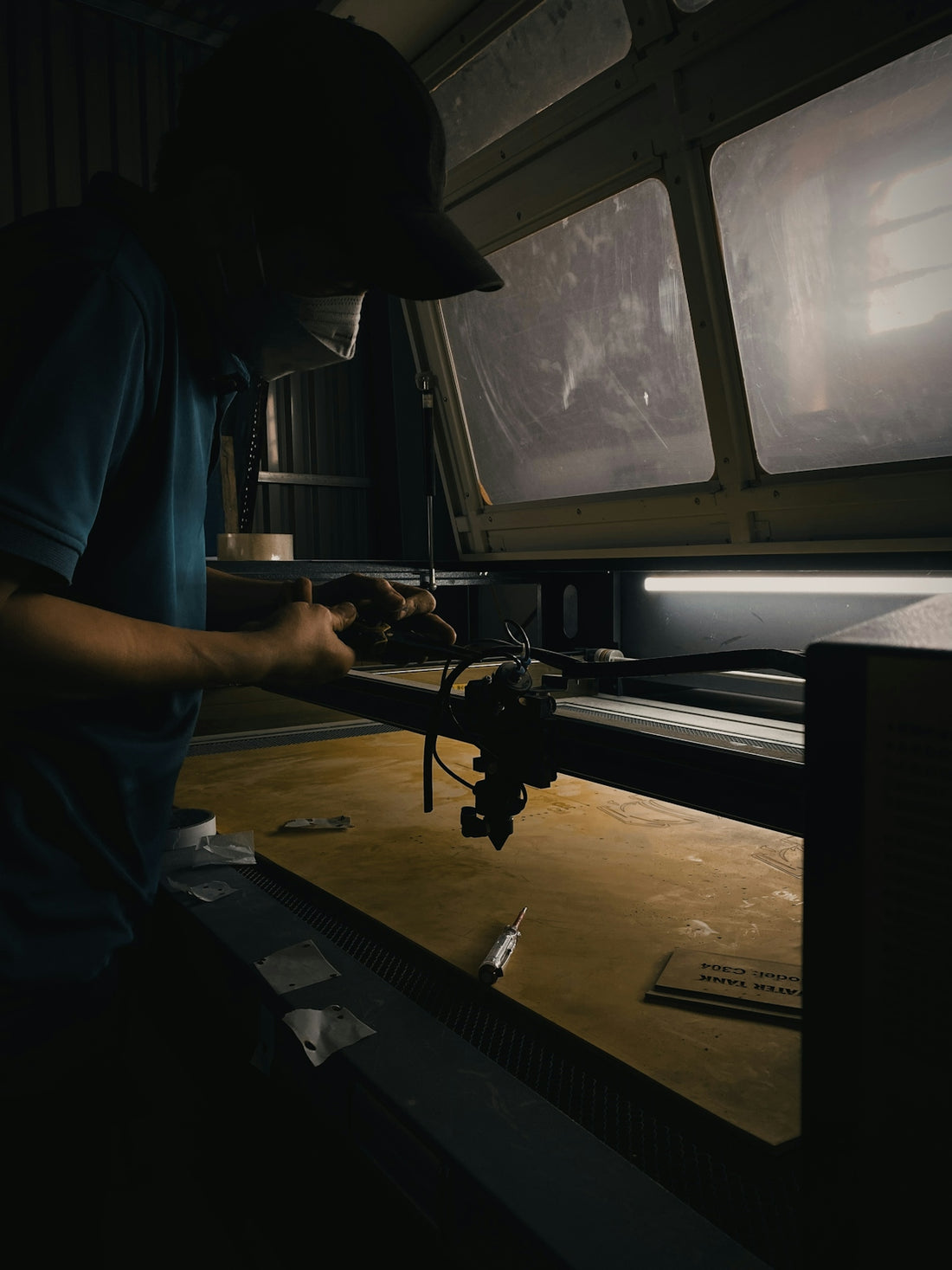 a man working on a machine in a dark room