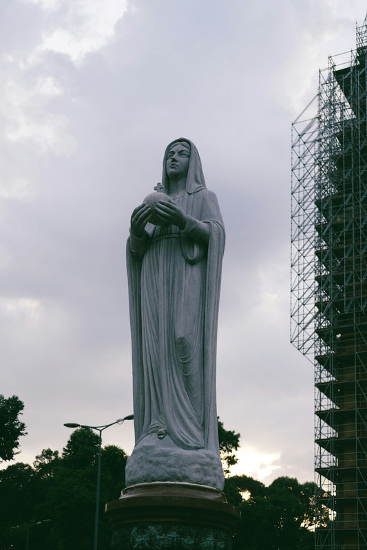 a statue of a person holding a staff