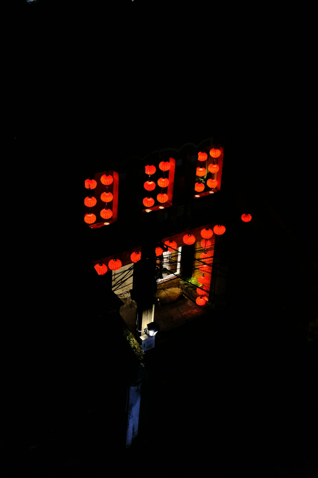 a building with red lights in the dark