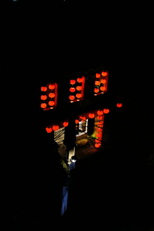 a building with red lights in the dark