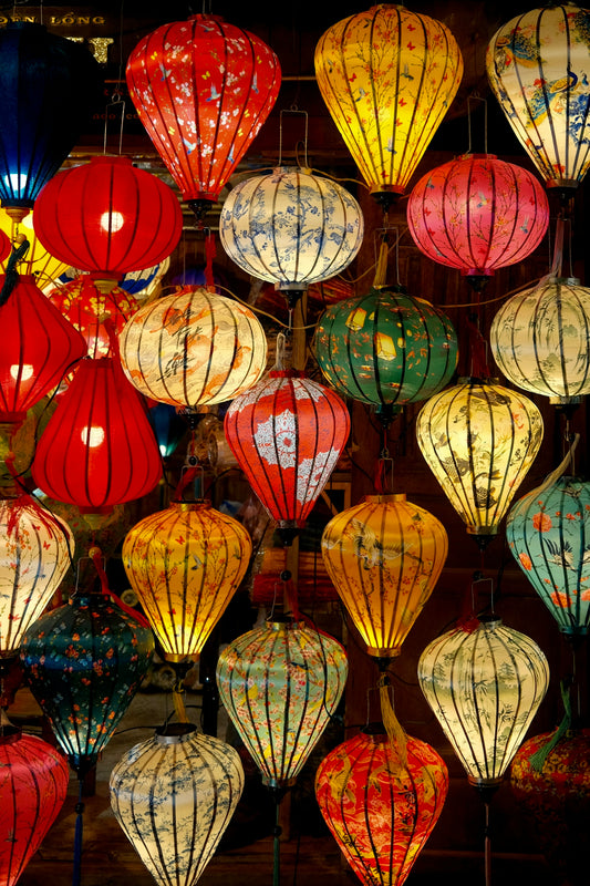 a bunch of colorful lanterns hanging from a ceiling