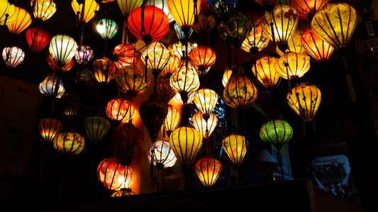 A bunch of lanterns are lit up in the dark